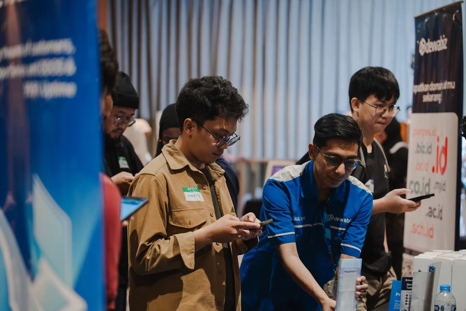 Attendees trying a product on their phones at a partner booth